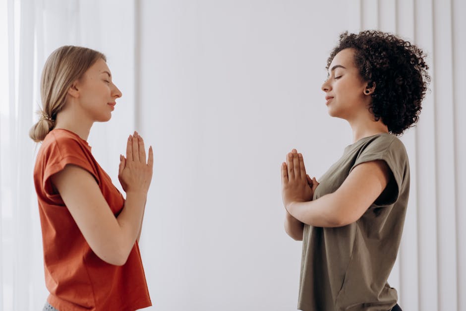 Person practicing a simple and gentle yoga pose in a comfortable home environment.